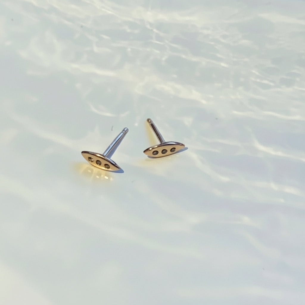 A tiny shield for protection, adorned in diamonds. Tiny earrings carved by hand by Jeffrey Levin in wax before being cast in precious metals. Cognac Diamonds set in Rose Gold.