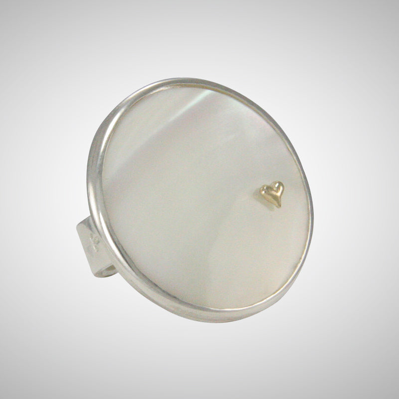 We love the luminescent white mother of pearl ring embellished with Jeffrey's tiny 14K yellow gold heart charm, pinned through the shell.