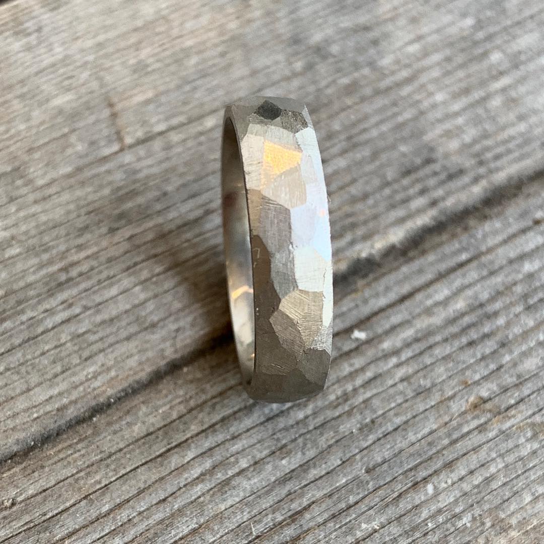 Jeffrey's hand carved wedding band in platinum has facets that captures the light. A unisex wide ring it is a modern option on its own or stacked with an engagement ring for stunning textural contrast. Platinum wedding band