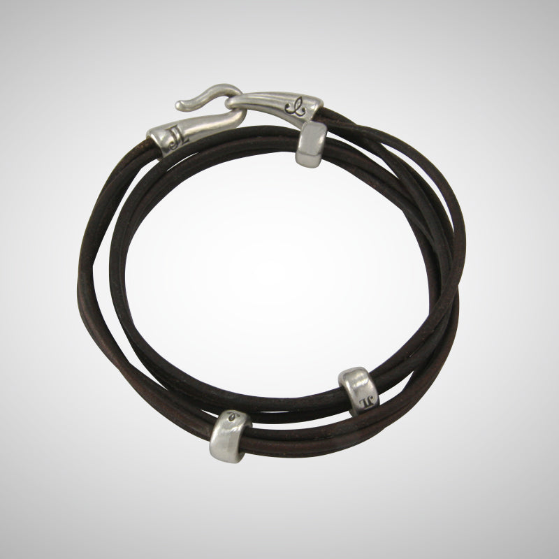 Jeffrey's double wrap leather bracelet is a modern and versatile streetwear accessory. The specially designed handcrafted sterling silver hook and eye clasp is reimagined from the old Roman style. The black leather wrap is embellished with 3 handcrafted sterling silver "donut" beads.