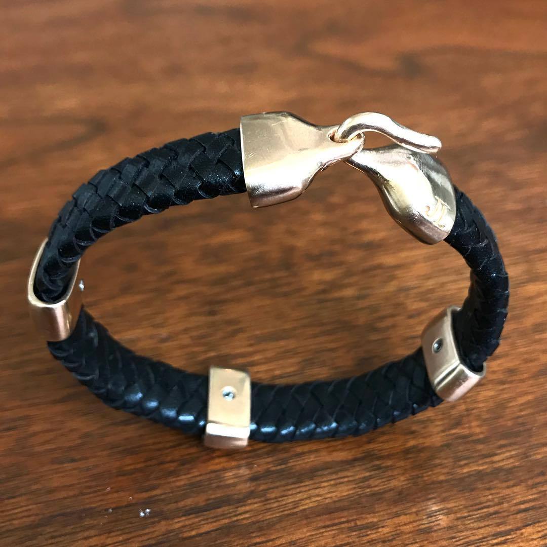 Jeffrey Levin sterling silver and braided black leather bracelet with 3 silver bands and handcrafted sleek hook clasp.