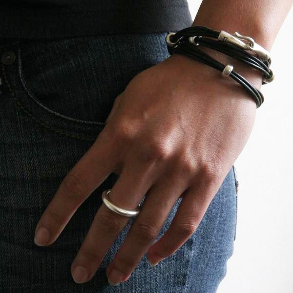 Jeffrey's double wrap leather bracelet is a modern and versatile streetwear accessory. The specially designed handcrafted sterling silver hook and eye clasp is reimagined from the old Roman style. The black leather wrap is embellished with 3 handcrafted sterling silver "donut" beads.
