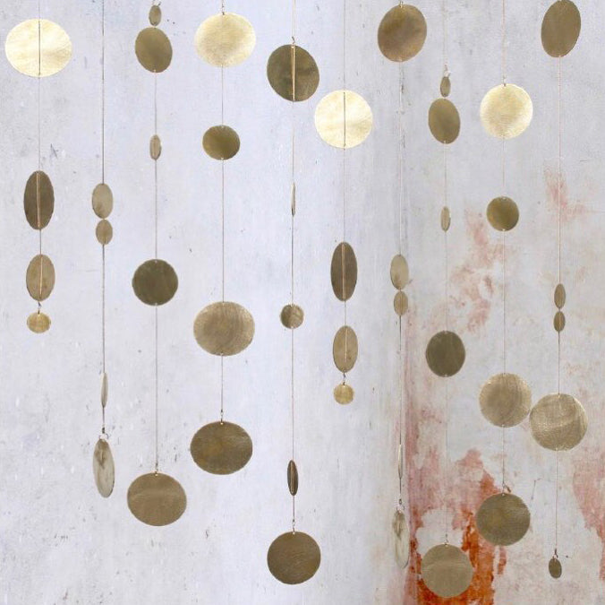 Rain is a beautiful hanging mobile made from brass. A single rain is beautiful wall hanging on it is own but a big cluster of rain makes a fantastic sculpture. Each Rain looks different as you can adjust the length and the placing of the circles.