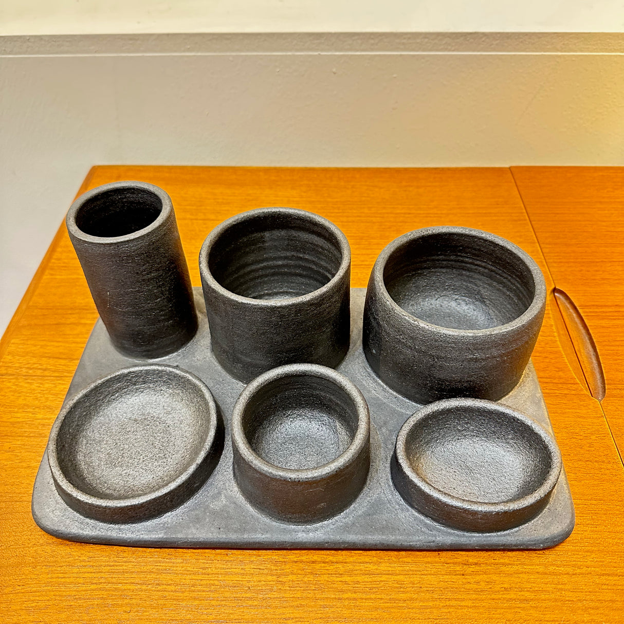 Ceramic organizer. For kitchen, think salt cellar, fresh herb storage, a dips presentation... For bath, think q-tips, cotton balls, bath salts, fresh flowers.