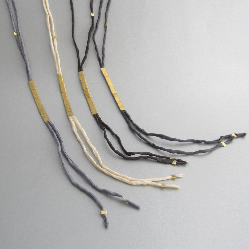 These long elegant necklaces were inspired by nature. In this case, earthworms (“Anellide” in Italian), and their serpentine flow, helped create the language for these designs.