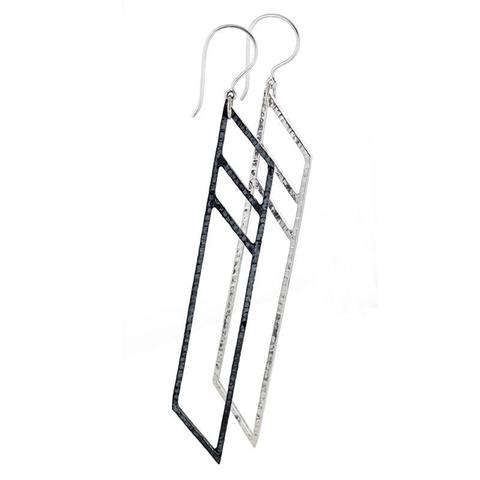 It's okay to be different. For these earrings by Mariella Pilato, one earring is oxidized black and the other is polished silver for a strong contrast.