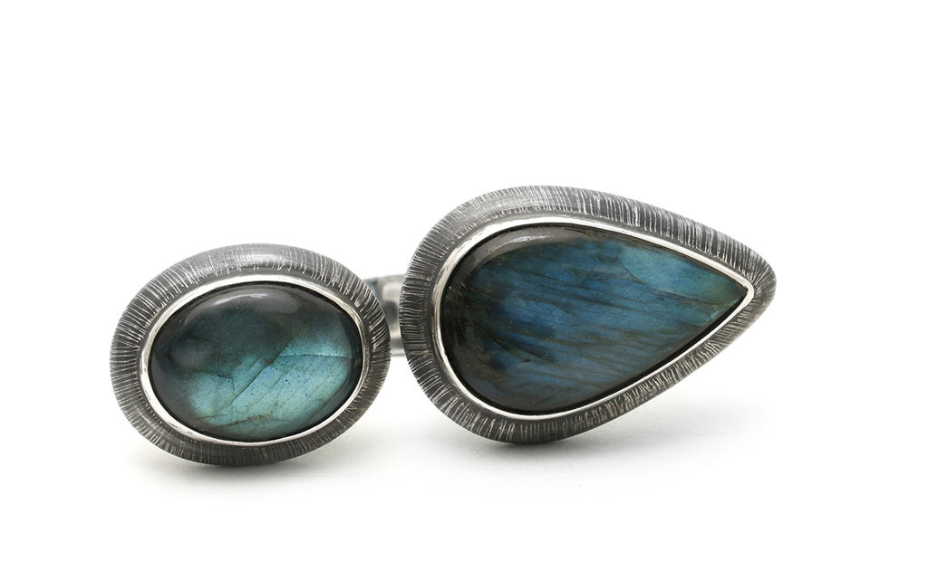 Oval and angular labradorite stones set in etched and oxidized sterling silver by Mariella Pilato. Front view