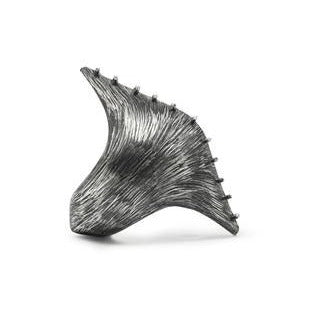 When you like a bold big ring... This dramatic elongated pod of polished bands of silver wire are constructed over a heavily etched silver container which opens slightly, revealing an oxidized interior. Side view.