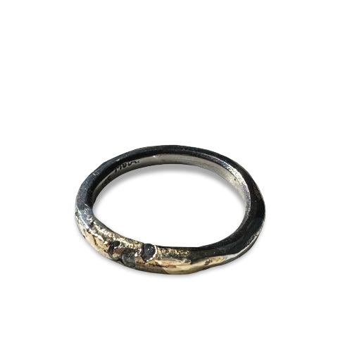 Mixed metals Lennard band has salt and pepper diamonds cast in place in the 14k gold and sterling silver stacking ring