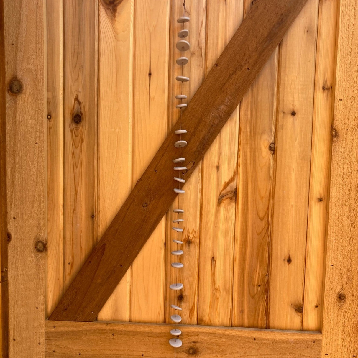 Pebbles is an extra long hand built ceramic wall hanging by Shimoda Ceramics with organic shapes that spin you right round.