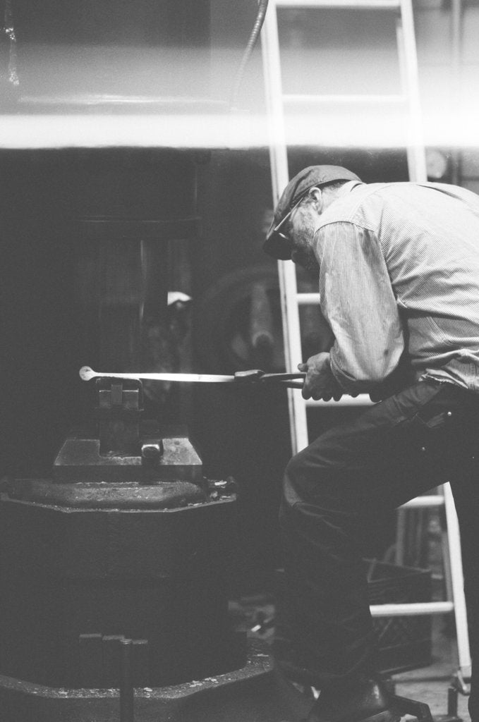 Forging the tongs in the workshop.