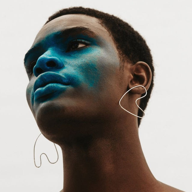 Anaid sculptural earrings on model.