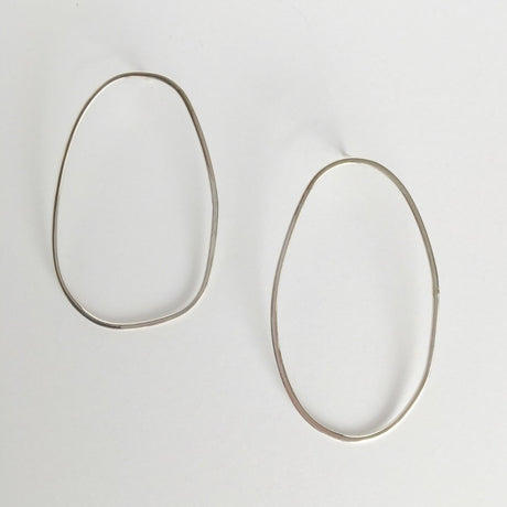 Asymmetrical oval olive-shaped sterling silver earring hoops boast a sophisticated yet modern aesthetic.