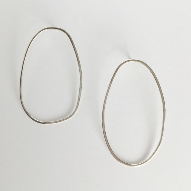 Asymmetrical oval olive-shaped sterling silver earring hoops boast a sophisticated yet modern aesthetic.