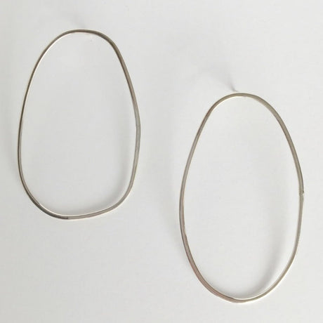 Asymmetrical oval olive-shaped sterling silver earring hoops boast a sophisticated yet modern aesthetic.