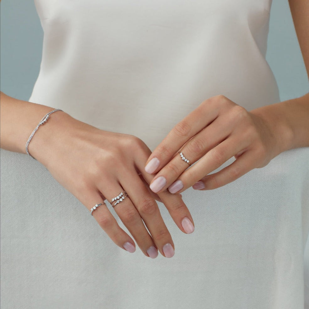 Light up your ring party with these delicate 5 diamond and 14K gold every day stacking rings. Shown on model across fingers