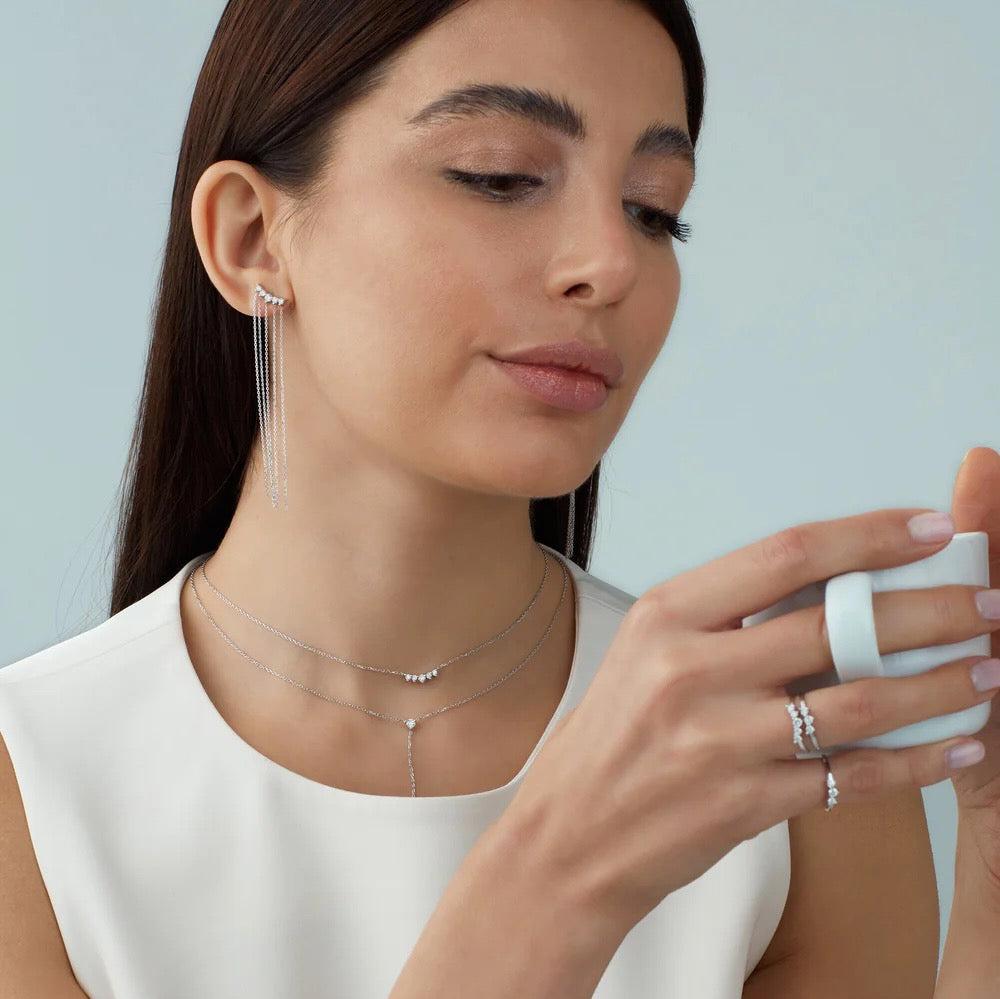 Five diamonds are clustered in a slightly curved bar in this elegant necklace. Sumptuous brilliant cut recycled diamonds are paired with recycled 14K yellow gold, rose gold or white gold chain. Shown layered with a Y diamond necklace on model.