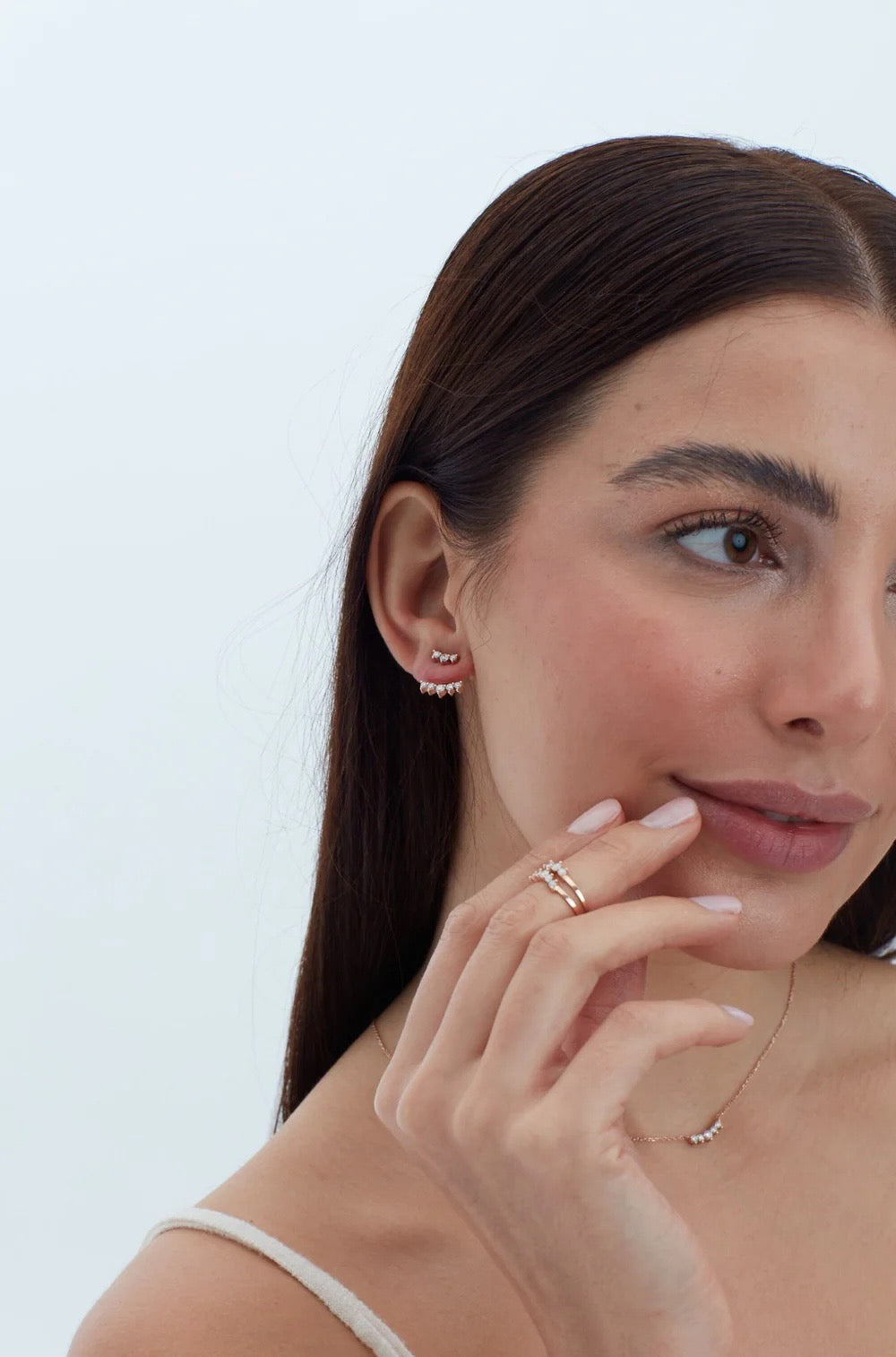 Five diamonds are clustered in a slightly curved bar in this elegant necklace. Sumptuous brilliant cut recycled diamonds are paired with recycled 14K yellow gold, rose gold or white gold chain. Shown with a 3 and 5 diamond ear jacket and 5 stone rings.