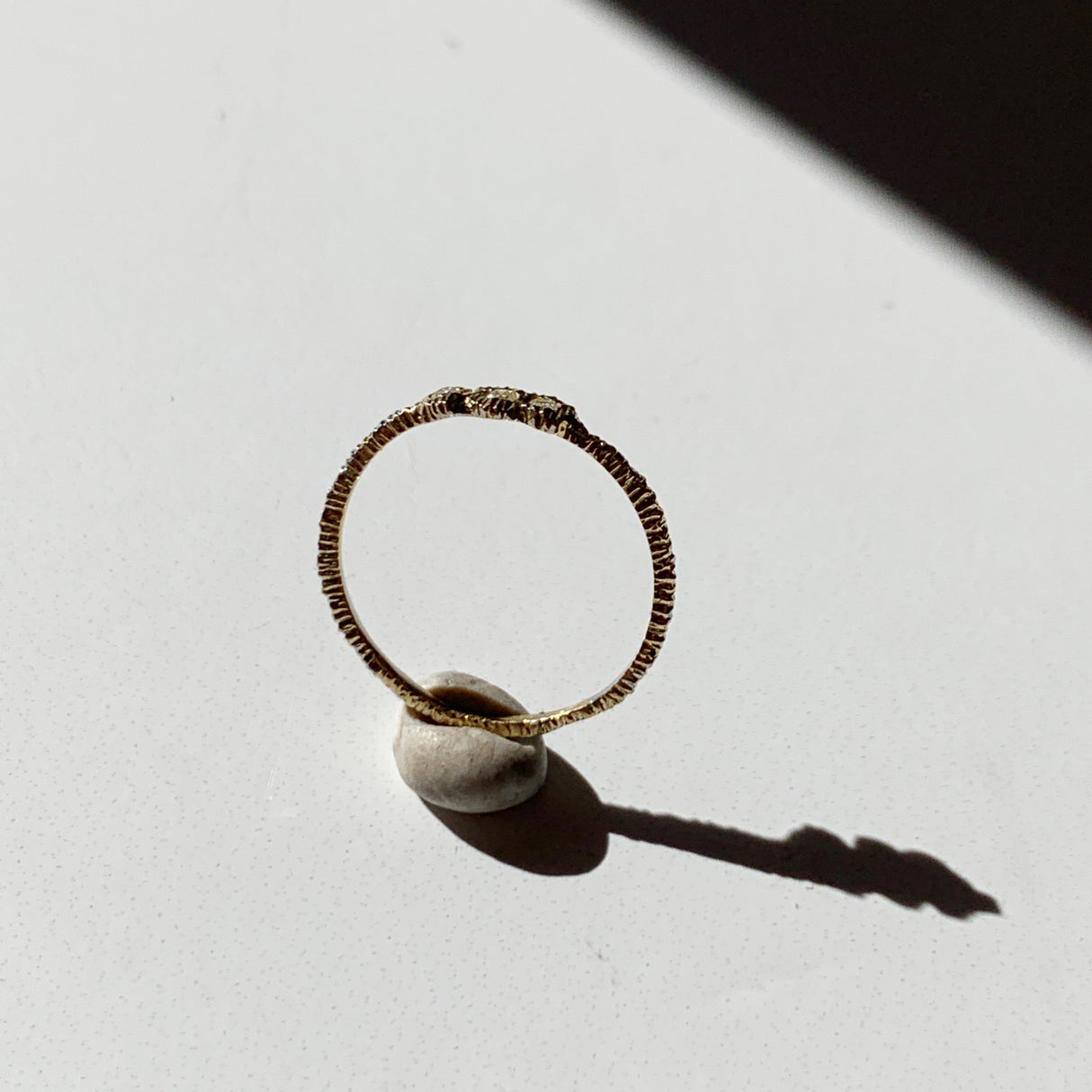 Danielle Welmond elegant yellow gold super skinny etched band set with three white diamonds.