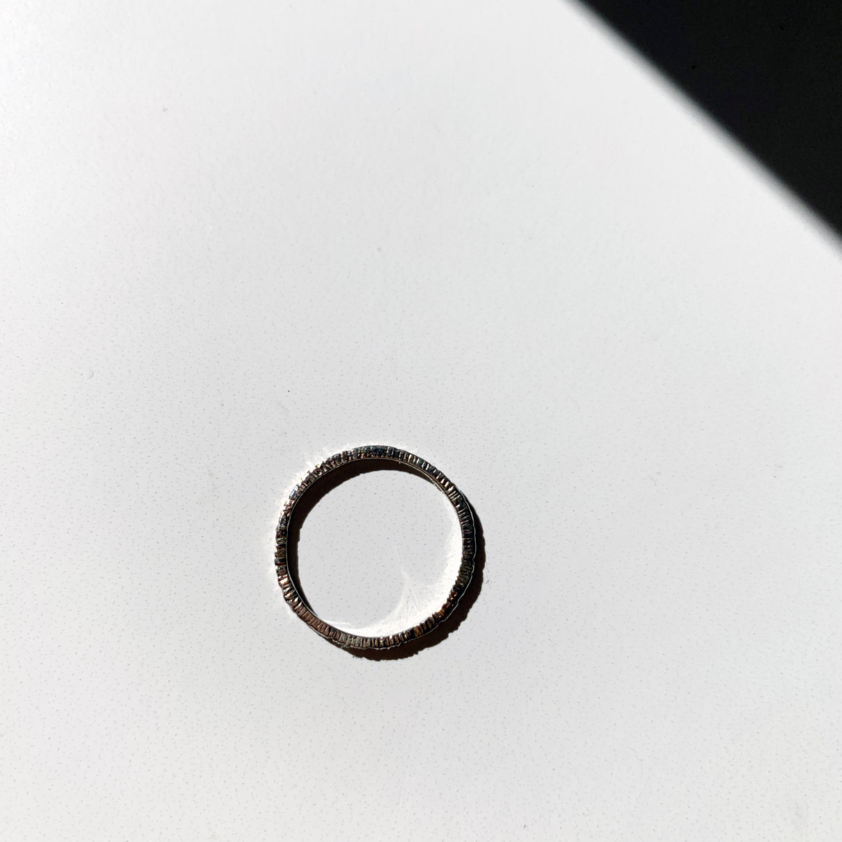 Add texture to your ring stack with this simple, elegant white gold super skinny etched bands.