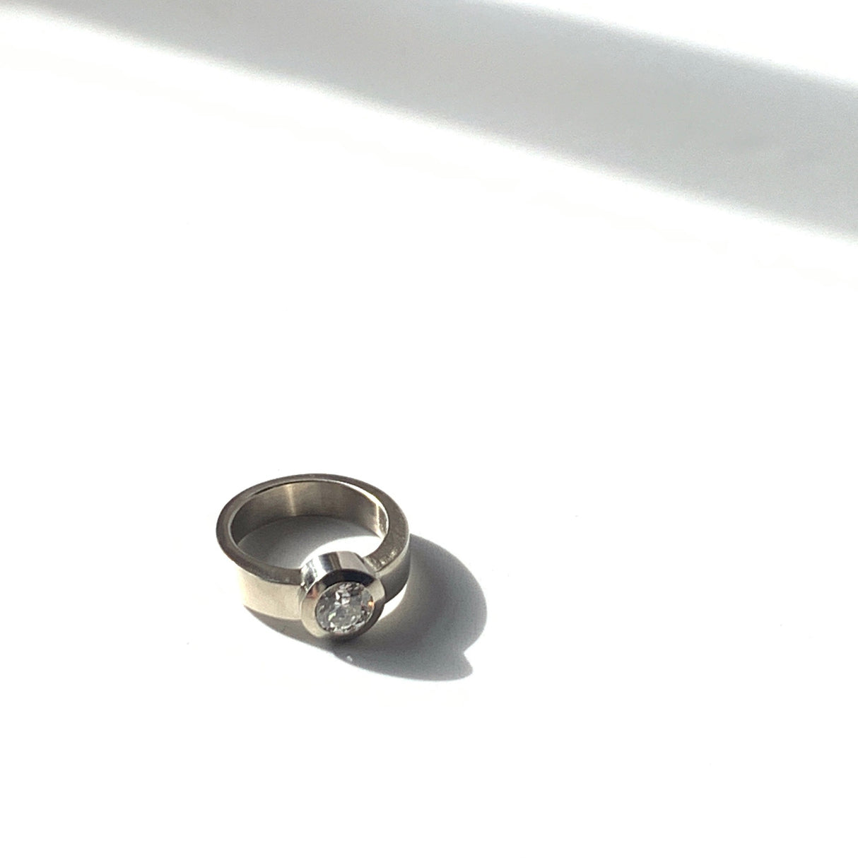 The mounting was hand carved in wax and cast in white gold with Jeffrey’s signature flush-set design.