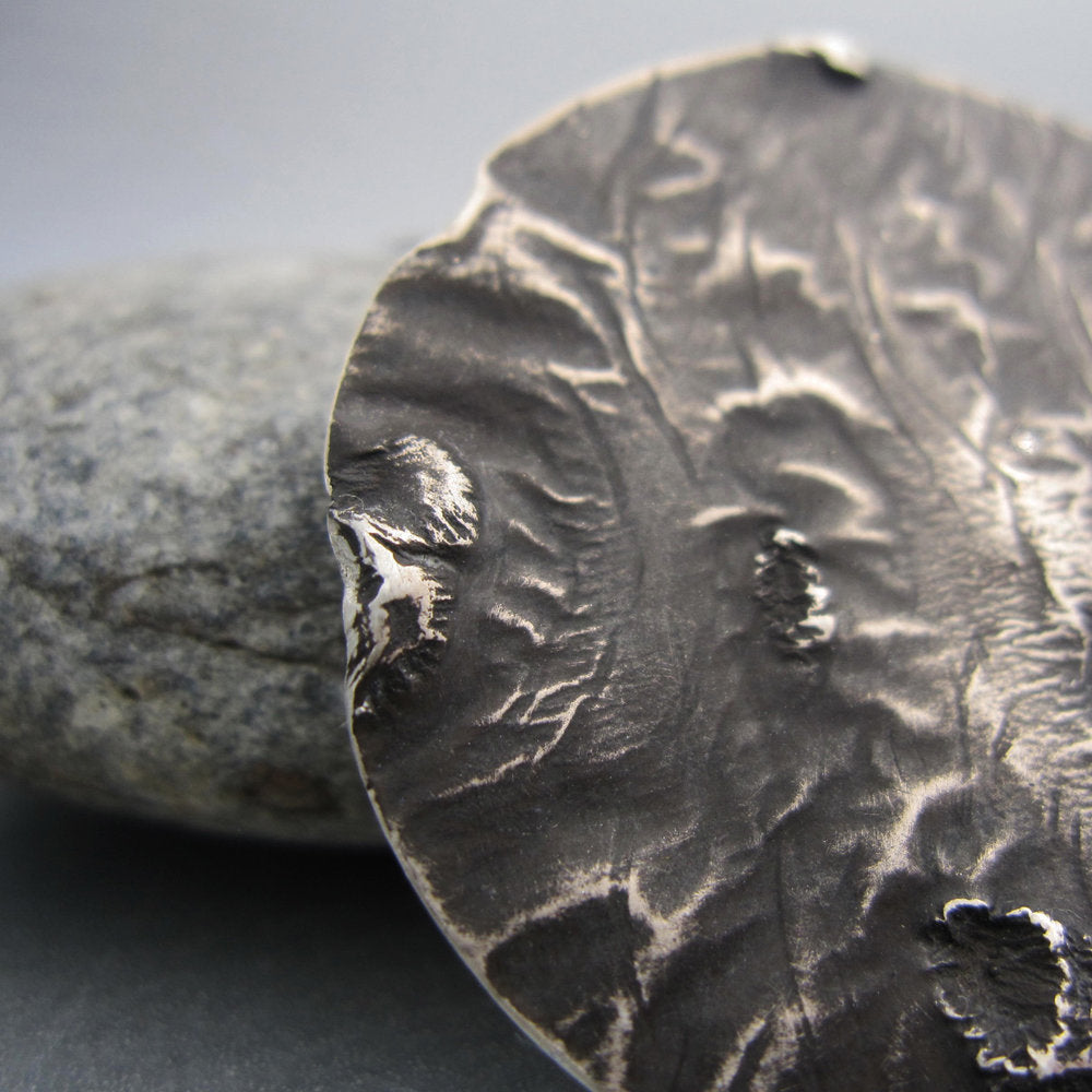 We love the bold meets activism aesthetics of this large medallion with whale tail.