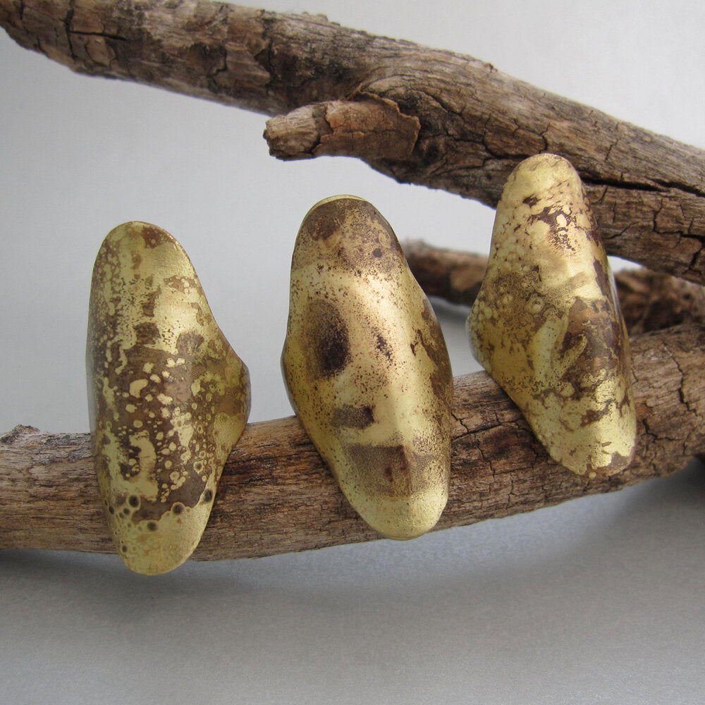 Group of knuckle rings with torch work that gives them a scorched look.