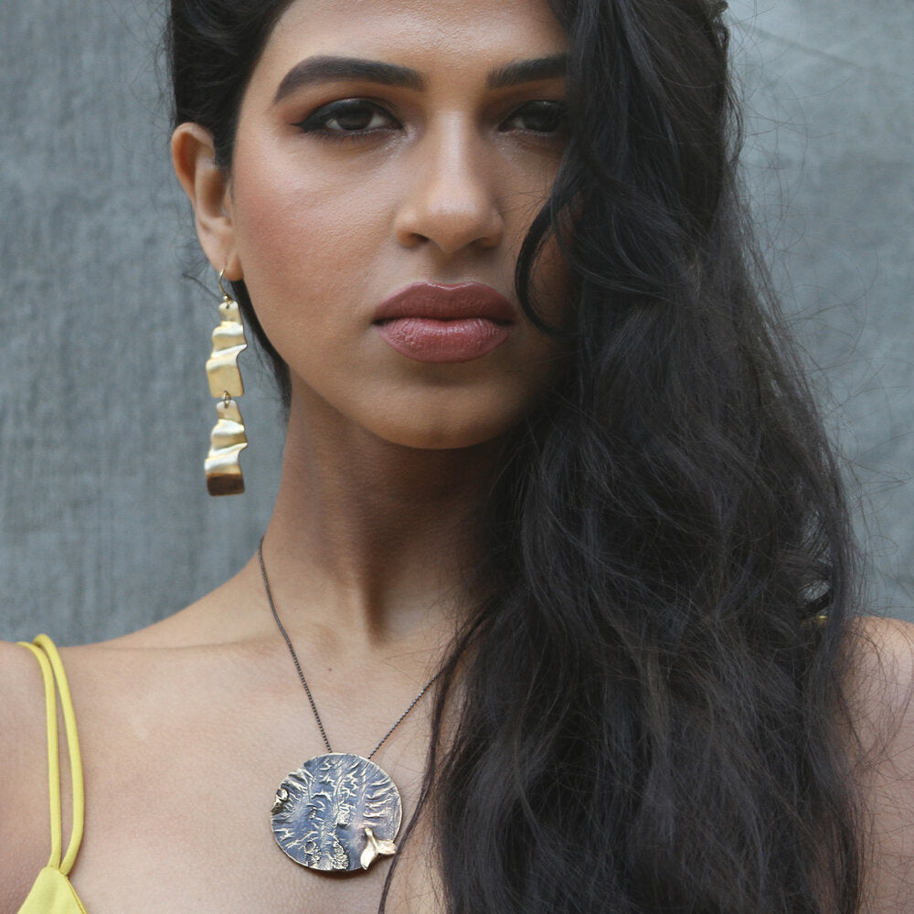 We love the bold meets activism aesthetics of this large medallion with whale tail.