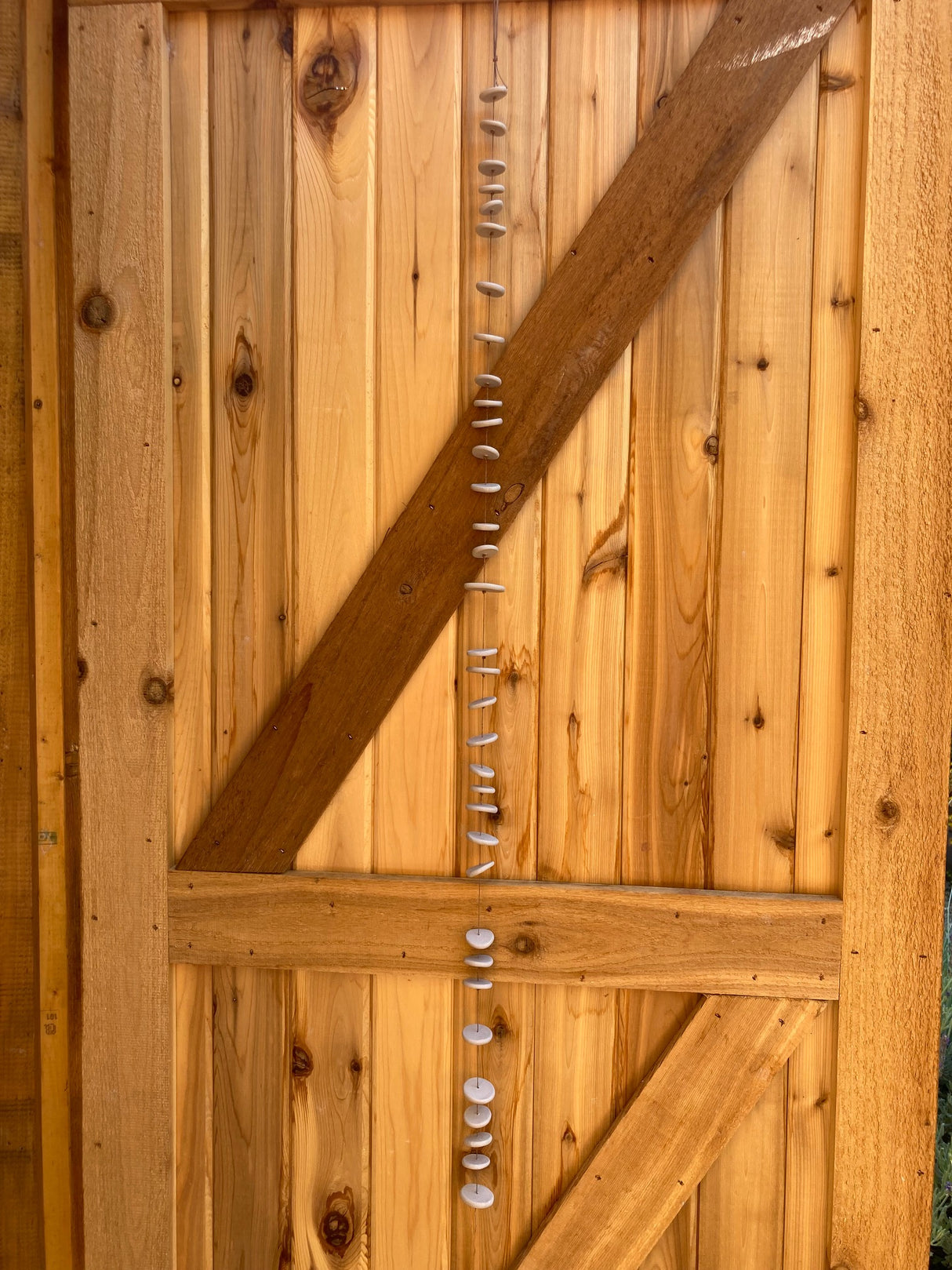 The freeform discs of the ceramic Pebbles wall hanging by Shimoda Ceramics have a visceral quality, inspired by observations of landscape, the natural world, textiles, and metallic elements.