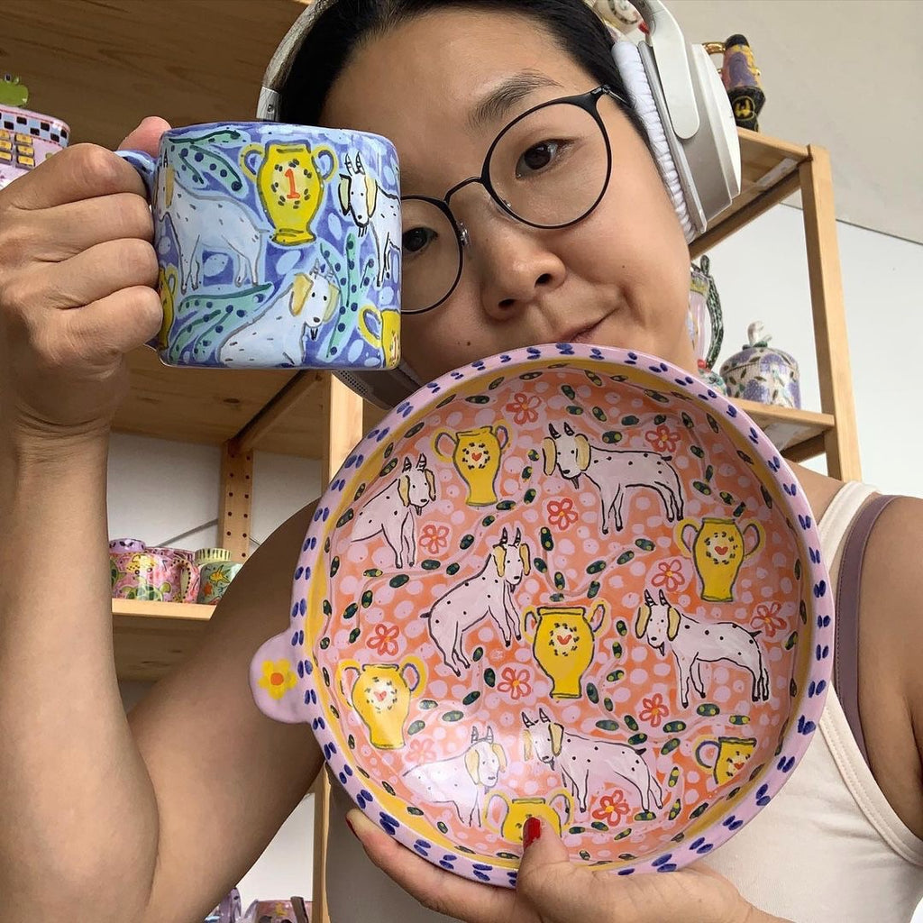 Humor drives a lot of the ideas Michelle Im of RatxChicks has for her ceramic forms and especially, their decoration. A Korean-American artist, she explores ideological tensions she experienced growing up in South Korea and America. 