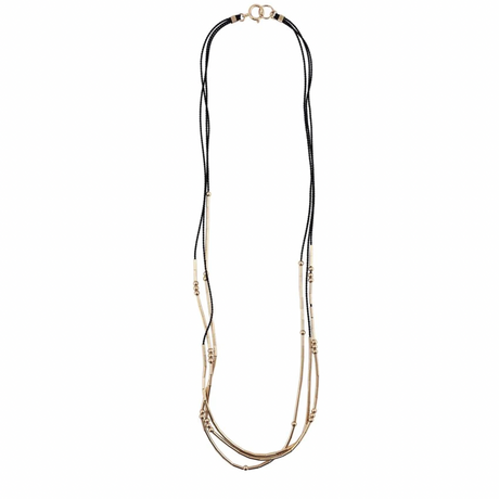 The Pictor is a triple-stranded silk cord necklace stacked with gold tubes and rounds that shift freely. 