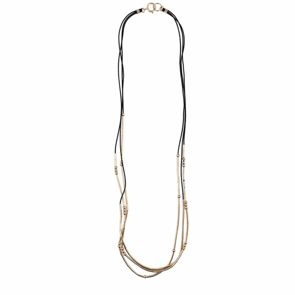 The Pictor is a triple-stranded silk cord necklace stacked with gold tubes and rounds that shift freely. 