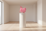 Pink ceramic unicorn figurine on a white background