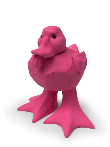 Pink ceramic duck sculpture with its tongue sticking out