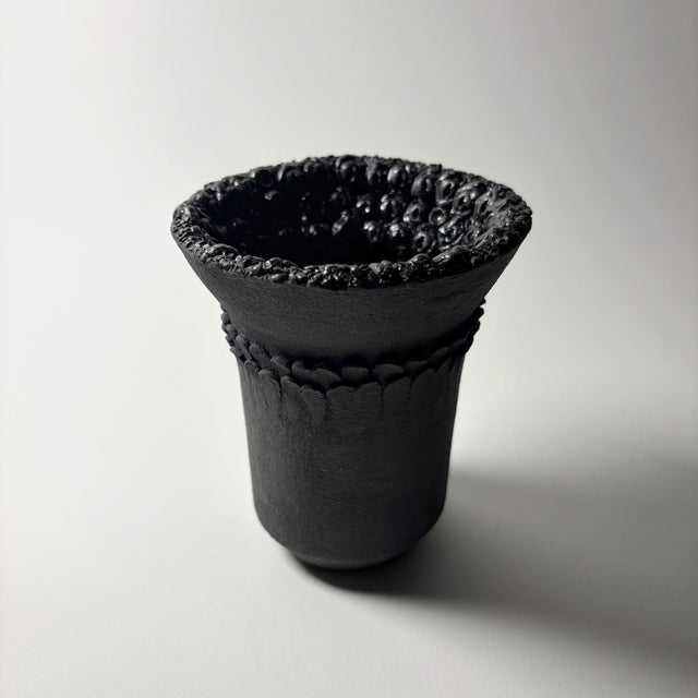 Dark Holding Vase in black clay  with intricate details inspired by the resilient plants of the desert, their forms and textures