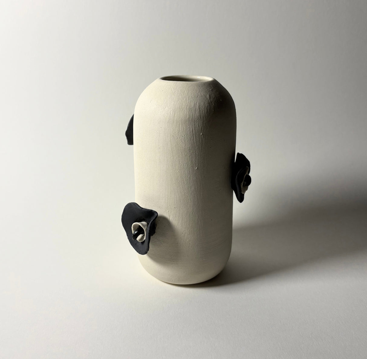 Narrow Petals and Claws Vase. With intricate attached flowers and claw thorns. 