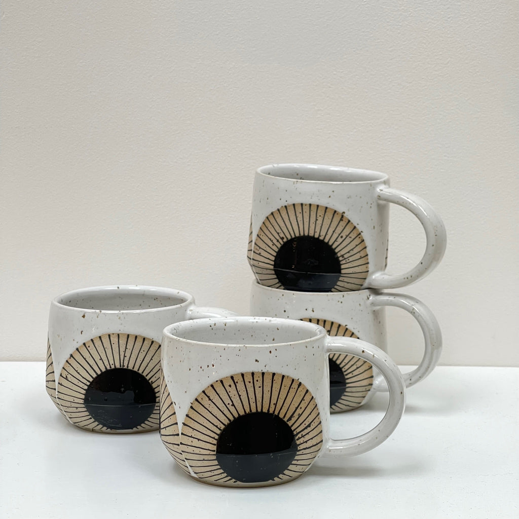 We love the repeating Black Sun design on this ceramic mug with handle by Julems Ceramics… apropos for a sunrise cup of coffee or sundown herbal tea.
