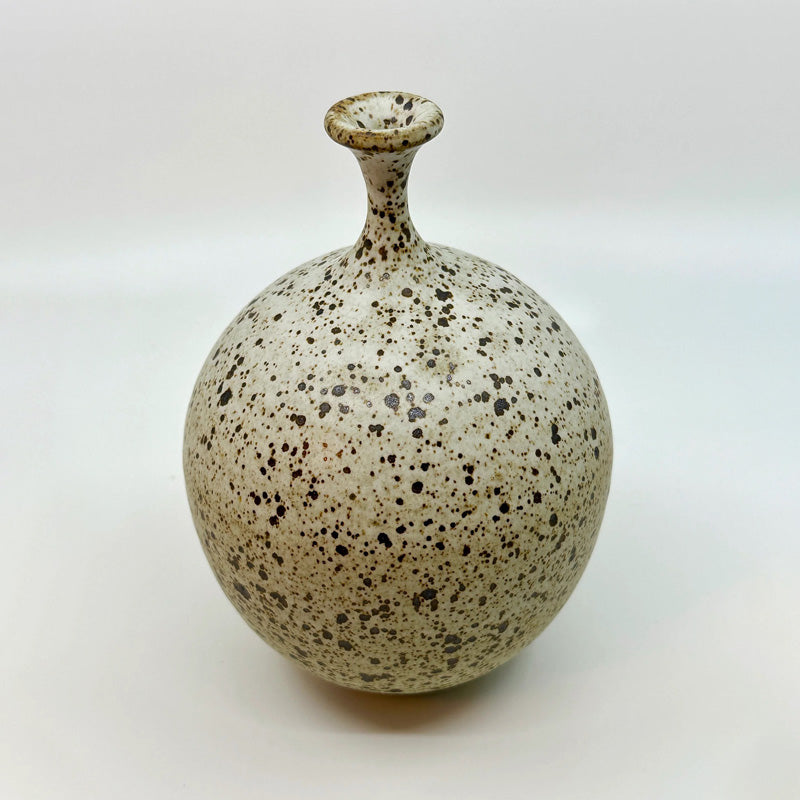 Dana Chieco's bottleneck forms are a gorgeous take on this distinct style. Her version in this No 34 vase is a white speckled clay. Try it with a single weed stem or dried flower. This is a one of a kind ceramic vase–a testament to the timeless beauty of heirloom pottery.
