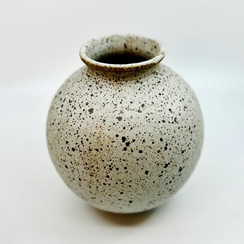 Dana Chieco No 36 wide mouth vase is wheel thrown and glazed in a white speckled clay. Try it with a single weed stem or dried flower. This is a one of a kind ceramic vase–a testament to the timeless beauty of heirloom pottery.