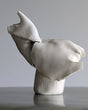 Abstract ceramic bird sculpture on a gray background