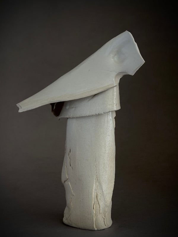 White abstract porcelain bird sculpture on a dark background. 