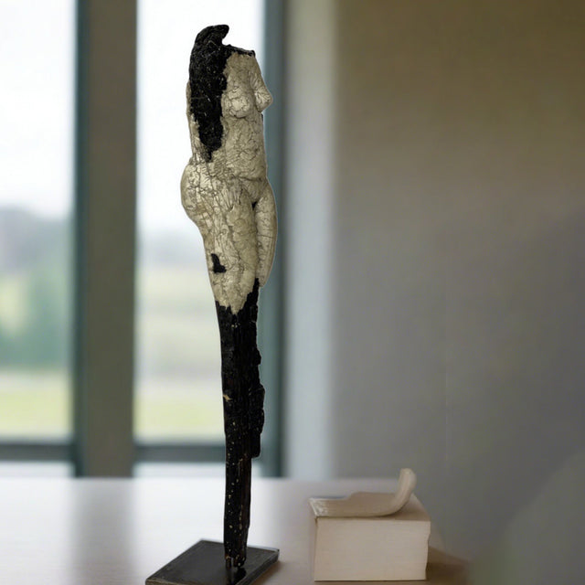 Female figure by Denise Carletta with sculpted clay around burnt wood and mounted on steel for placement on an entryway table or a dramatic centerpiece for a living room. Side angle view.