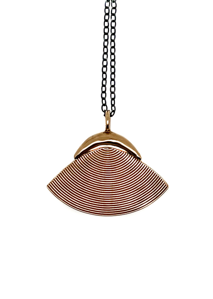 Detail of Elina Peduzzi shell pendant is an essential summer accessory. Wear it long or double the chain for a choker. Hand formed and cast in bronze with oxidized silver chain.