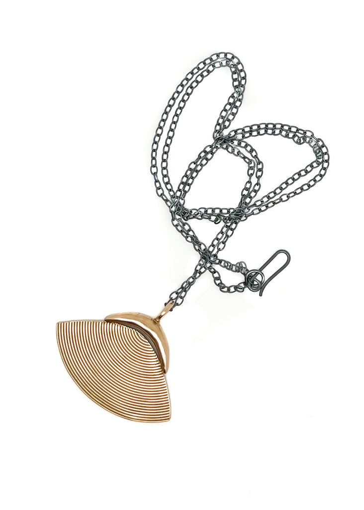 The shell pendant is an essential summer accessory. Wear it long or double the chain for a choker. Hand formed and cast in bronze with oxidized silver chain.
