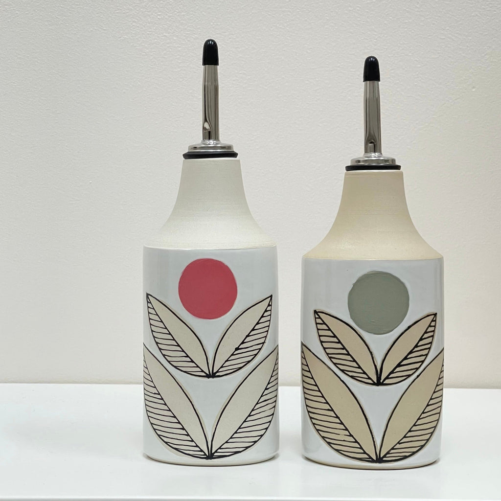 Your olive oil and vinegar pour just got an upgrade with these super cool oil bottles by Judith Lemmens, designer behind the Julems line of wheel thrown ceramics. The hand drawn design is a Julems feature. This one in a stylized flower pattern with a geometric olive or pink dot. 