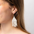 A subtle luminous shimmer, these lightweight and effortlessly cool woven beaded fringe earrings in ivory will be your everyday staple! Shown on model.