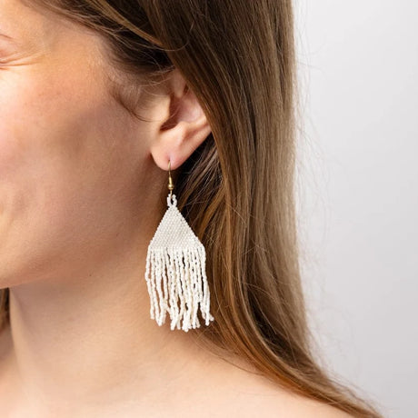 A subtle luminous shimmer, these lightweight and effortlessly cool woven beaded fringe earrings in ivory will be your everyday staple! Shown on model.