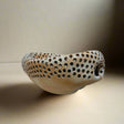 Ceramic bowl with perforated design 