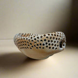 Ceramic bowl with perforated design 