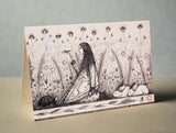 Illustrated card with a woman sitting among flowers and animals 